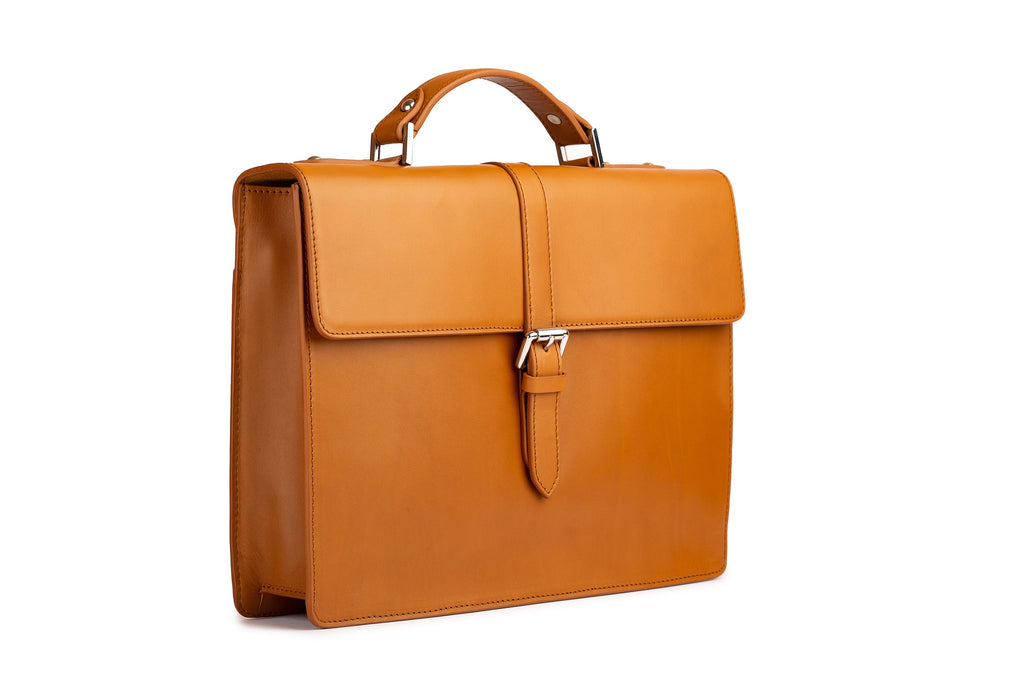 Tan leather briefcase side profile showing carry handle and shoulder strap