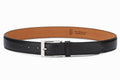 Black calfskin flat belt three-quarter front view showing nickel buckle