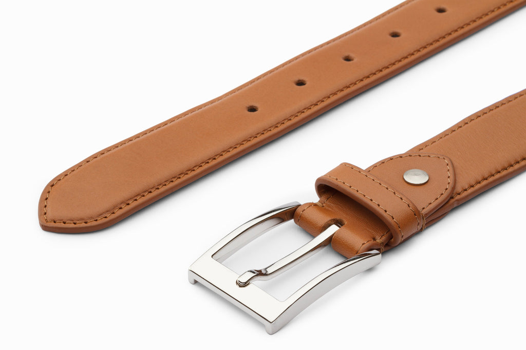 Tan leather flat belt close-up buckle and hole detail