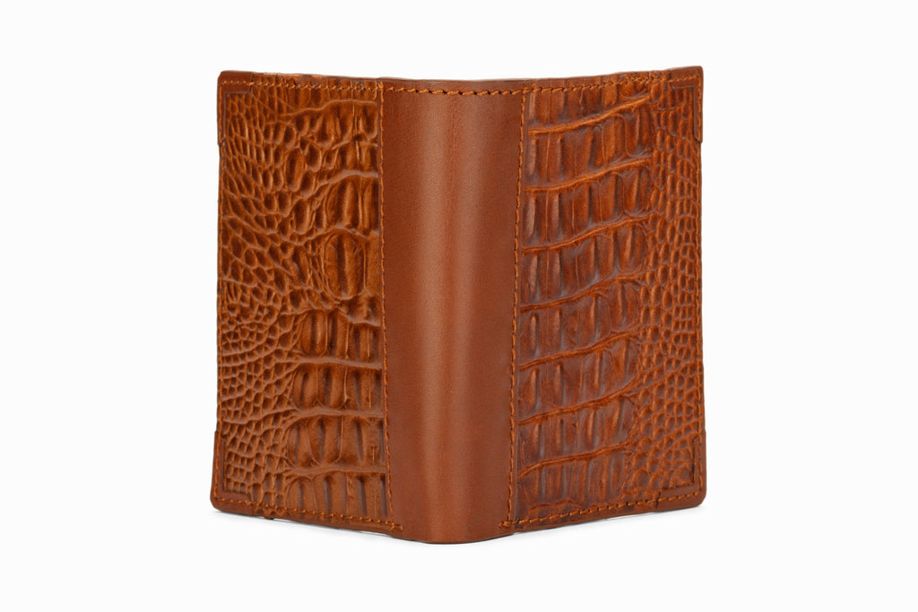 Brown crocodile pattern wallet side profile showing hip fold format