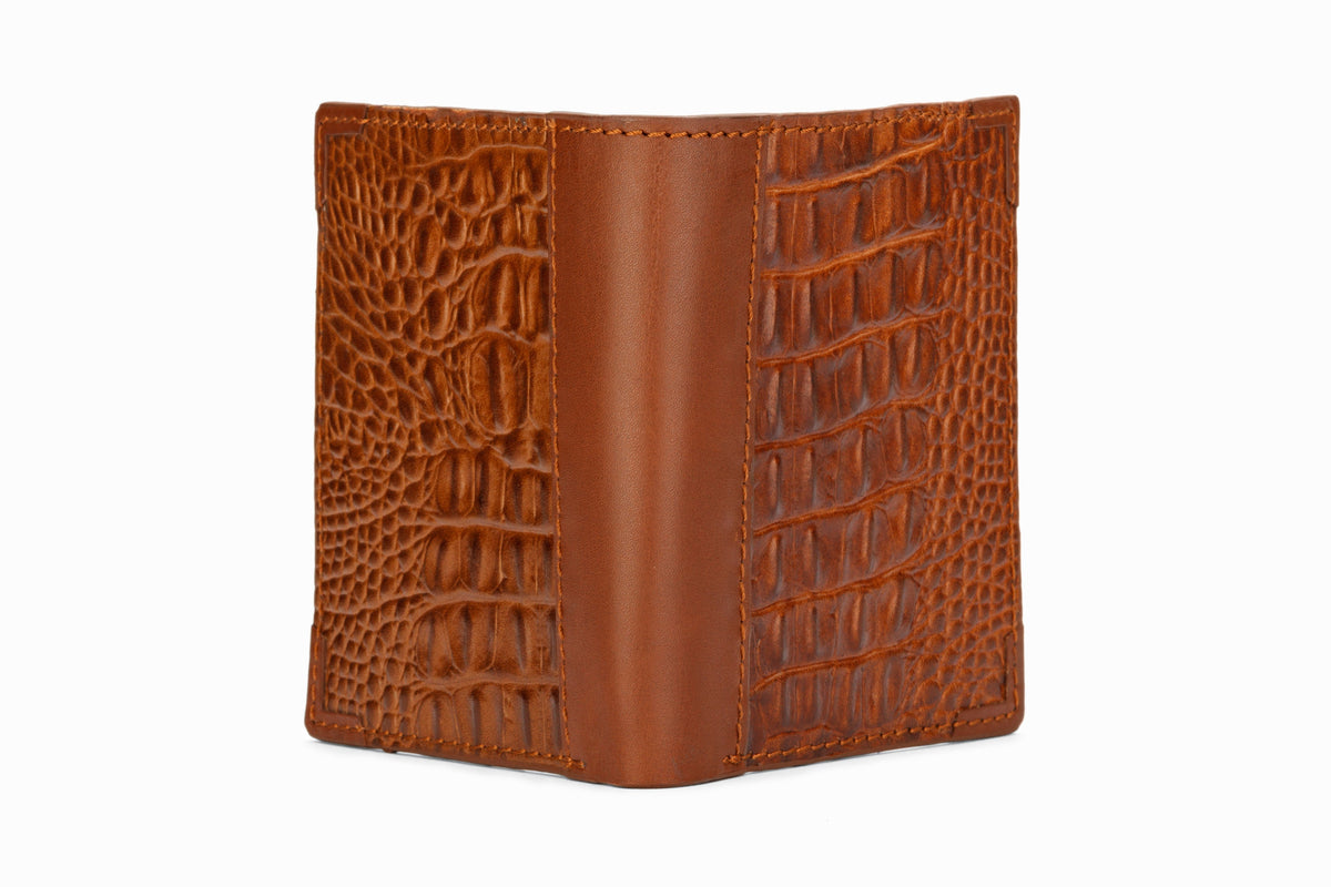 Brown crocodile pattern wallet side profile showing hip fold format