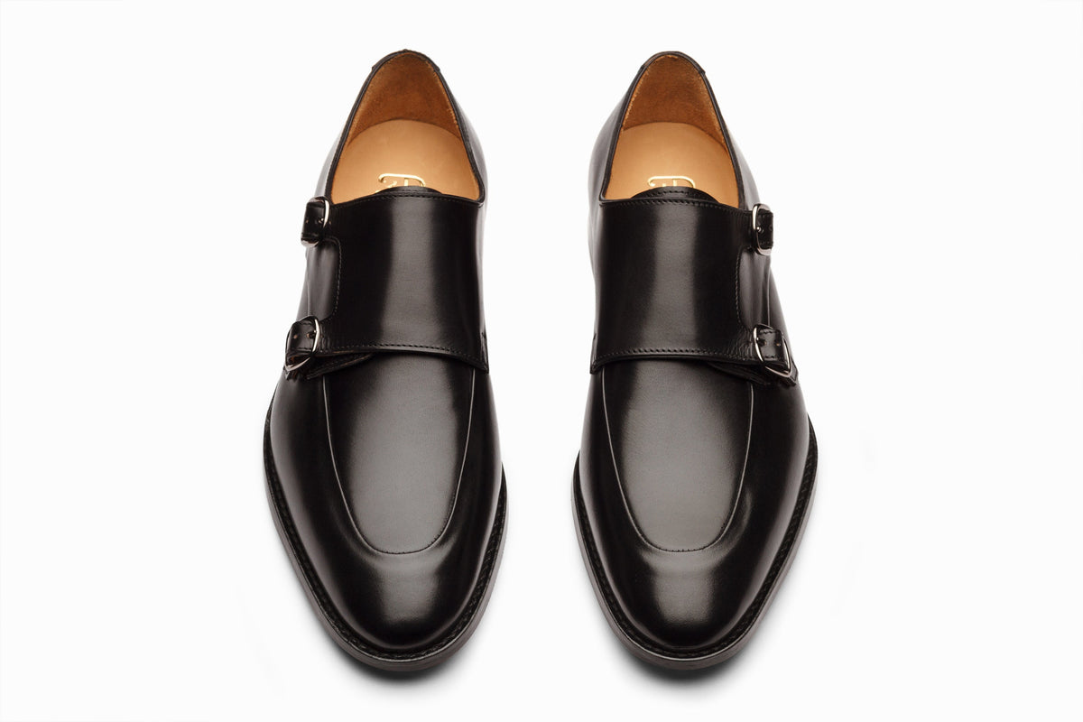 Black diplomat double monkstrap on-foot lifestyle shot with charcoal suit