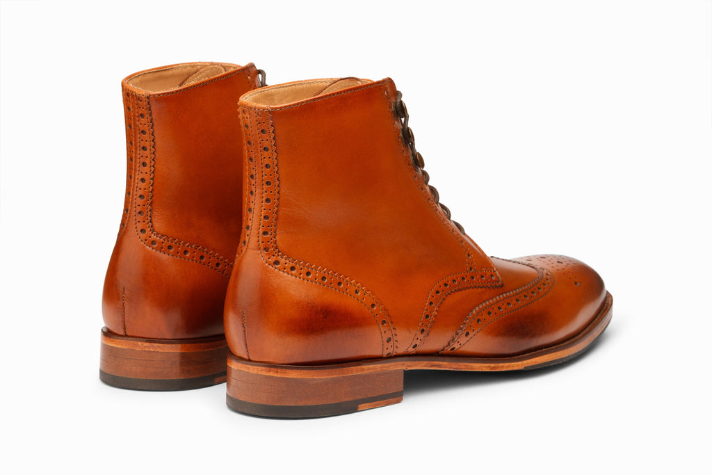 Wingtip Brogue Boot Tan on-foot lifestyle shot with dark chinos