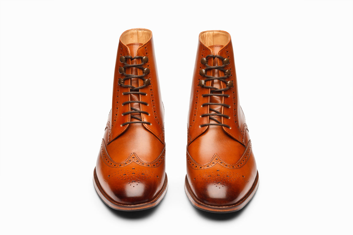 Tan wingtip brogue boot on-foot styled view showing brogue perforations