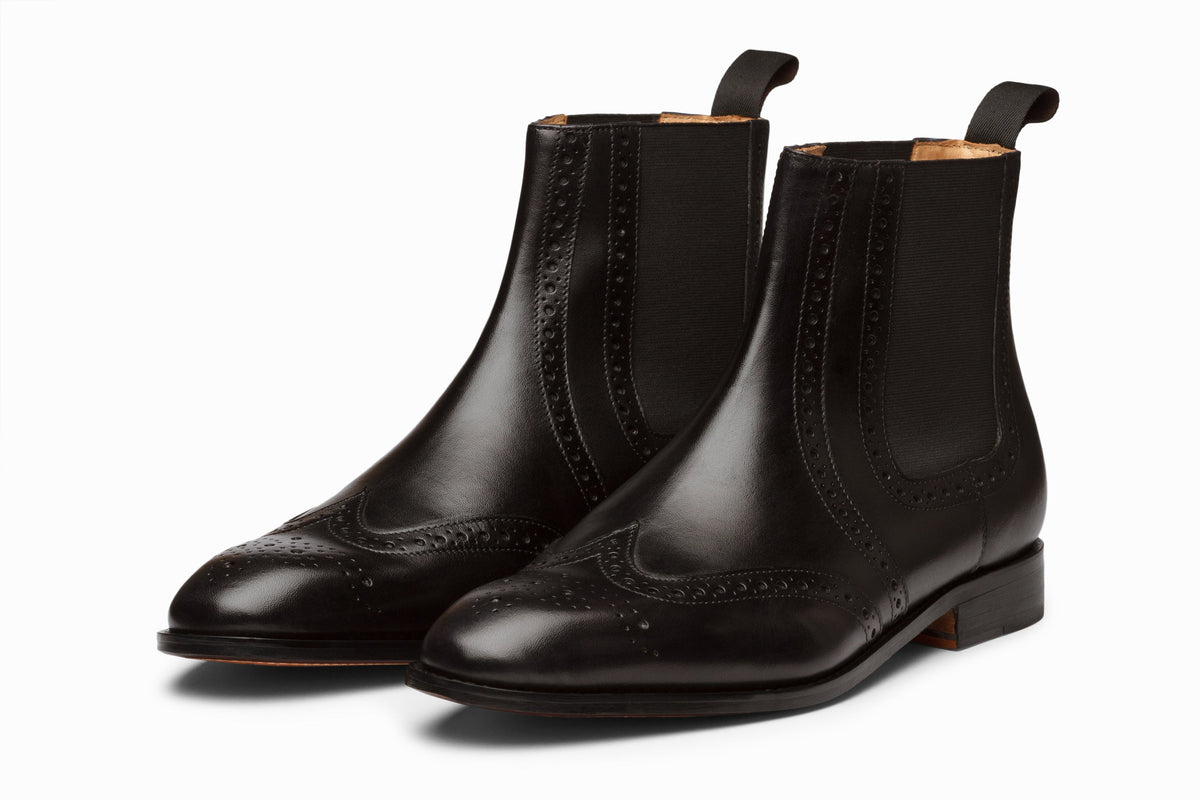 Wingtip Chelsea Brogue Boot Black side profile view on white background