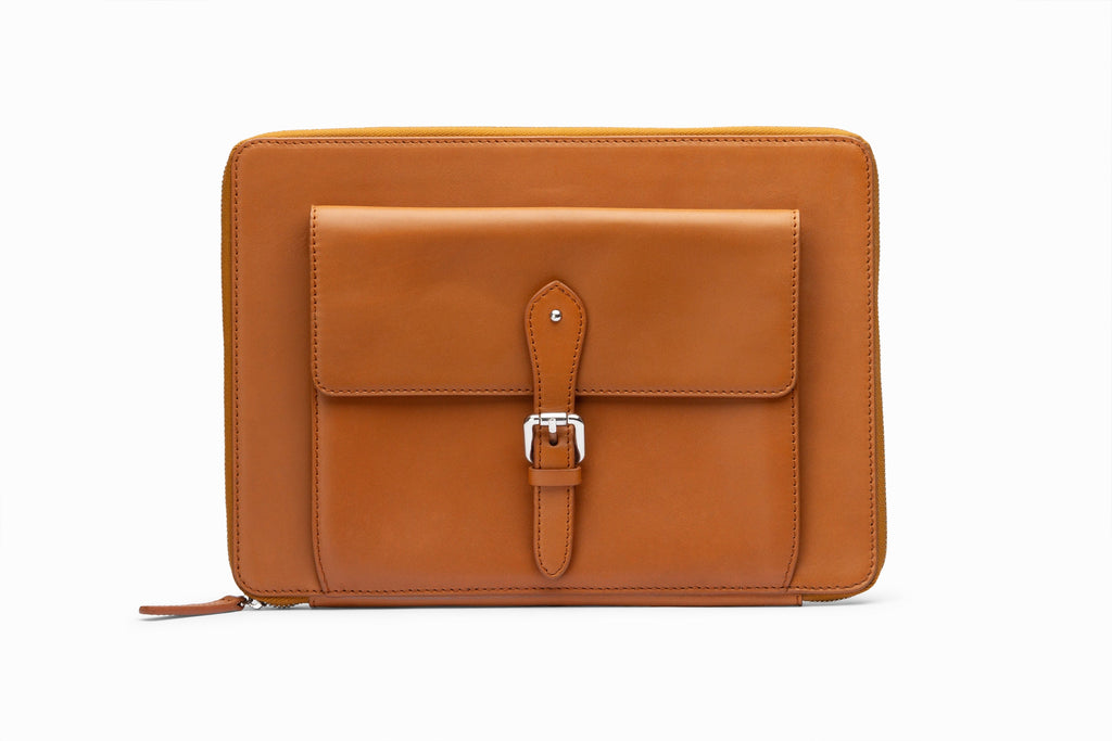 Tan leather laptop sleeve front view showing structured calfskin exterior