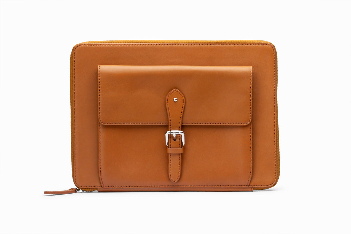 Tan leather laptop sleeve front view showing structured calfskin exterior