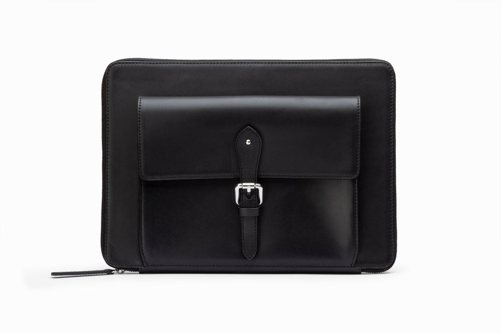 Black leather laptop sleeve front view showing structured calfskin exterior