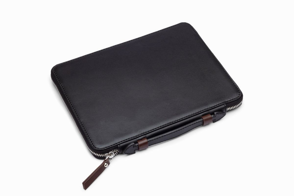 Black leather iPad case side profile showing slim leather construction