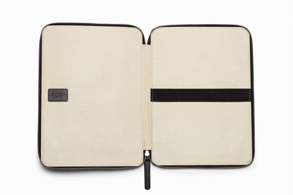 Black leather laptop sleeve top-down flat lay view on neutral background
