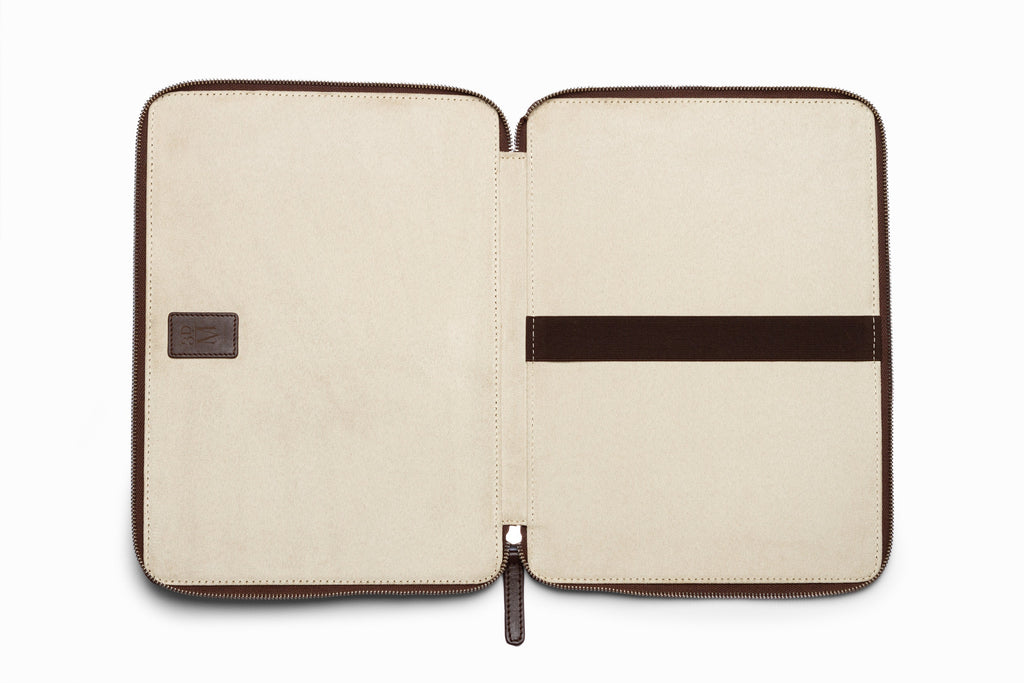 Dark brown leather laptop sleeve top-down flat lay view