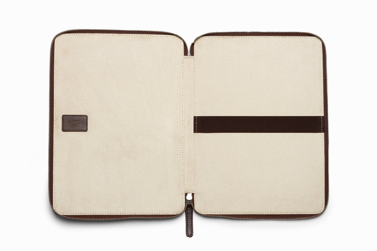 Dark brown leather laptop sleeve top-down flat lay view