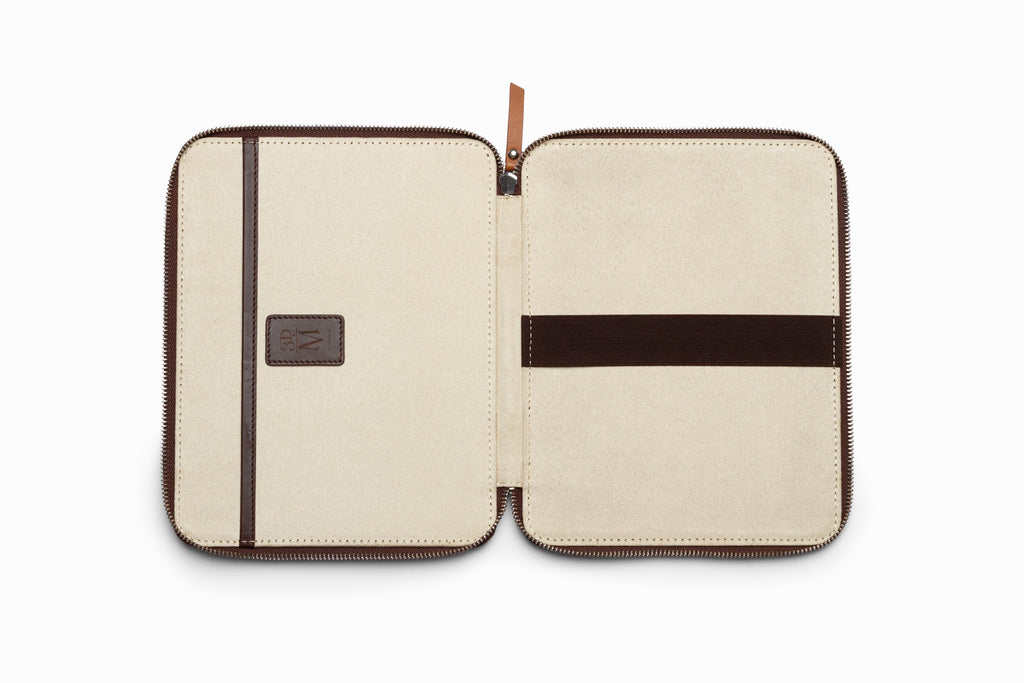 Brown leather iPad case top-down flat lay view on neutral background
