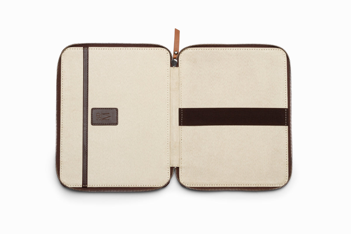 Brown leather iPad case top-down flat lay view on neutral background