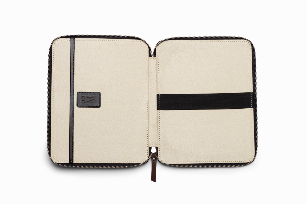 Black leather iPad case top-down flat lay view on neutral background