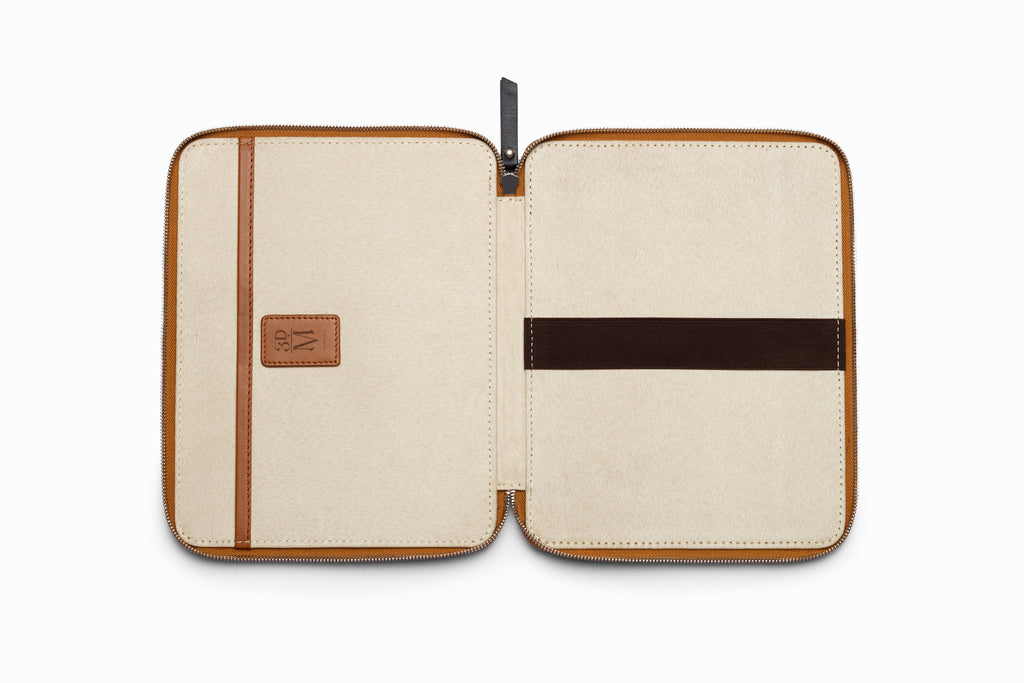 Tan leather iPad case top-down flat lay view on neutral background