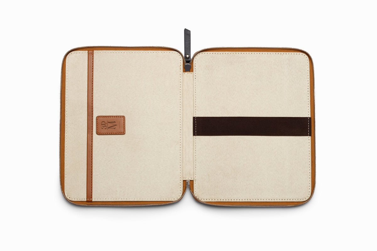 Tan leather iPad case top-down flat lay view on neutral background
