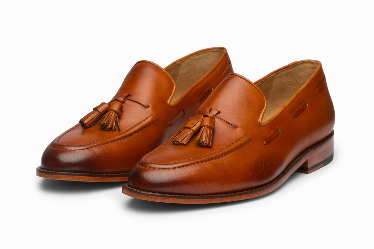 Tassel Loafers Tan three-quarter front view on white background
