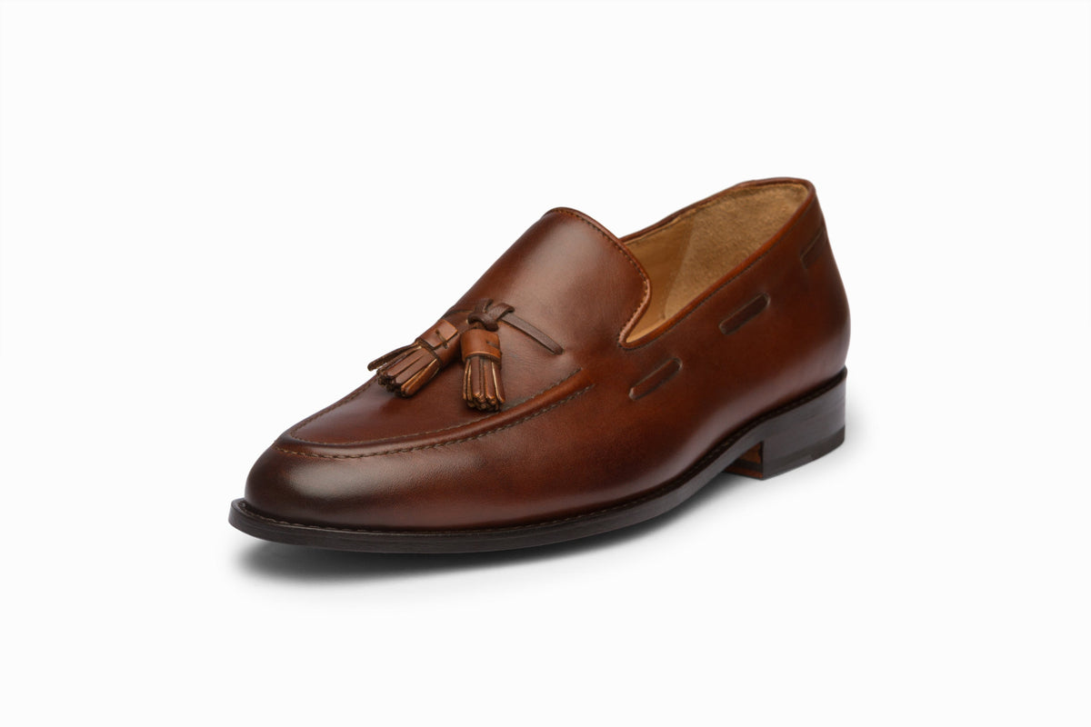 Tassel Loafers Brown top-down flat lay on neutral background