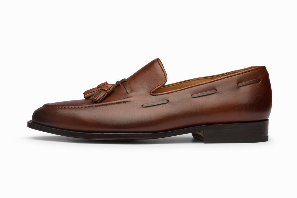 Brown tassel loafers three-quarter rear view showing heel