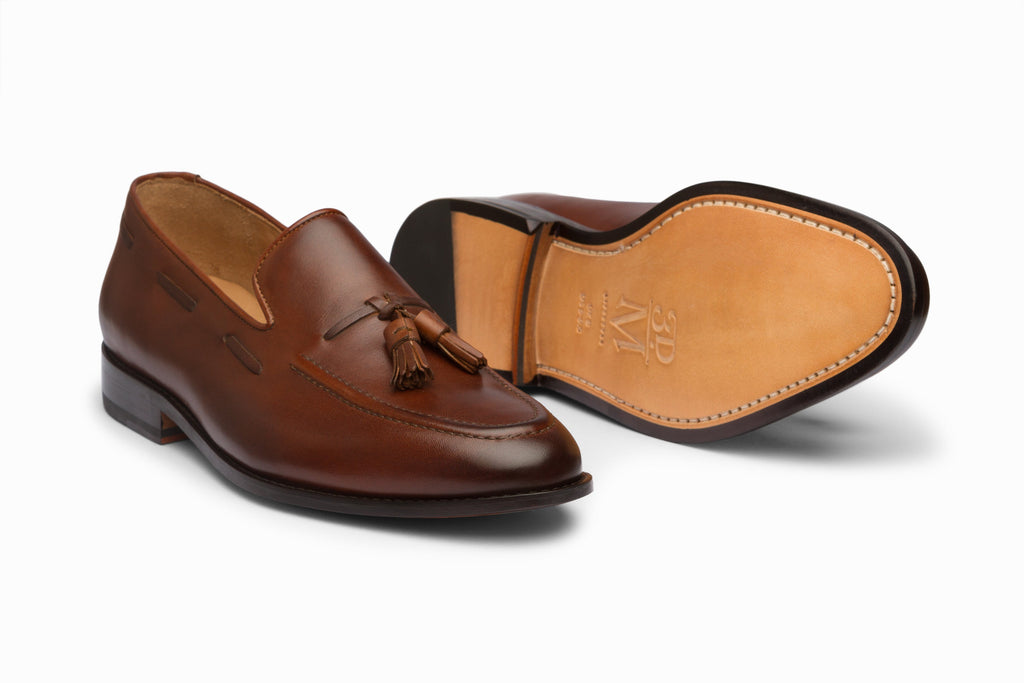 Brown leather tassel loafer close-up texture and tassel detail