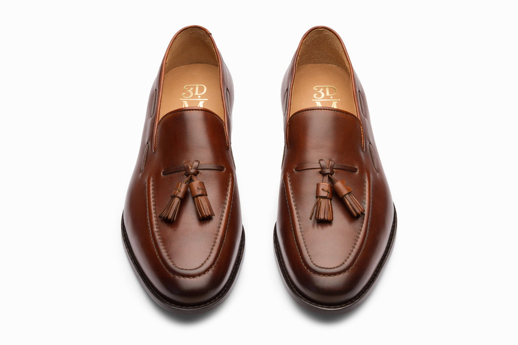Pair of brown tassel loafers top-down flat lay view