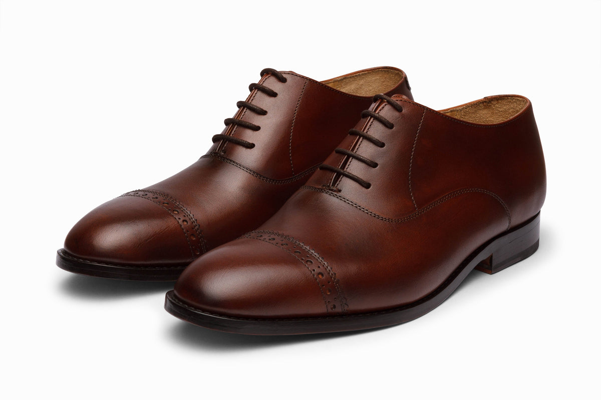 Quarter Brogue Oxford Brown three-quarter front view on white background