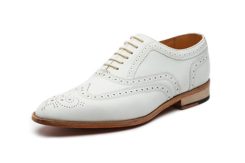 White leather Oxford close-up wingtip brogue perforation detail